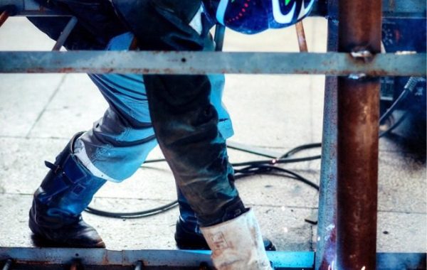 A professional welder providing mobile metal repairs to a ladder