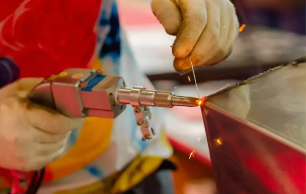 welder-hands-using-handheld