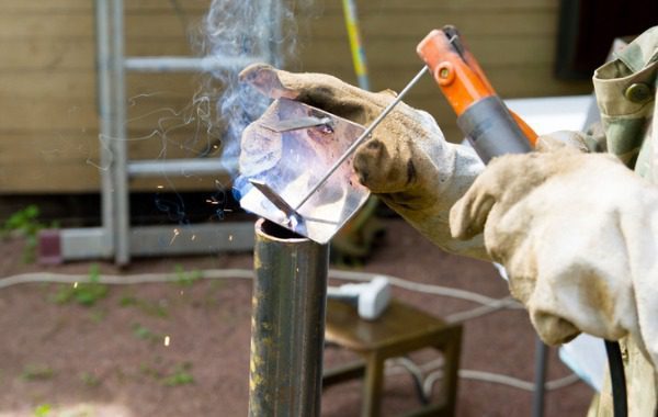 A welder is seen at a job site. 3D Welding Services is the best of the welding companies in Peoria IL.