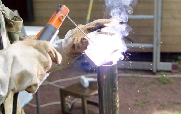 A welder is seen at work at a job site. 3D Welding Services is the best of the welding companies in East Peoria IL.