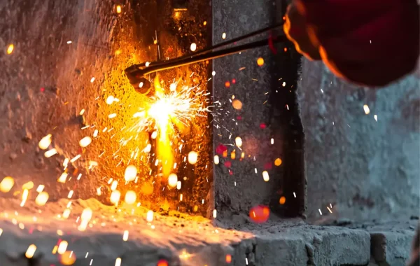 A professional helping fix a metal frame via custom metal repair in Illinois